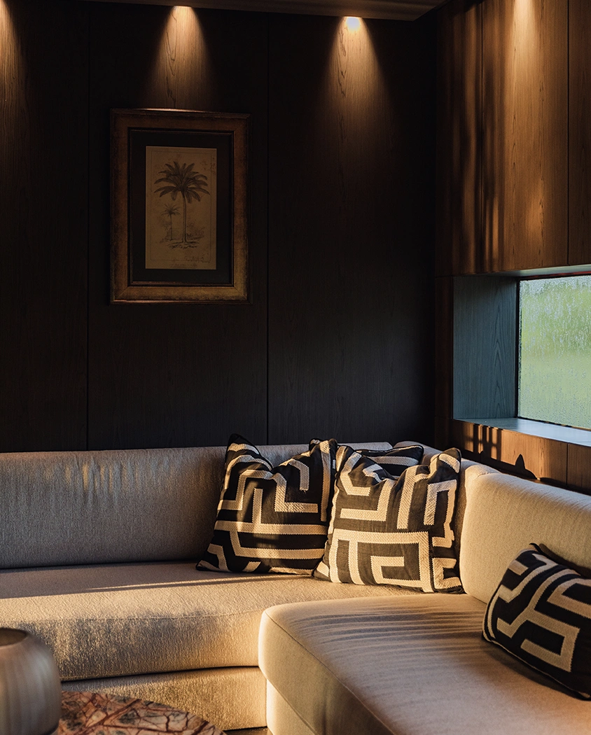 A lounge with sofas and patterned cushions