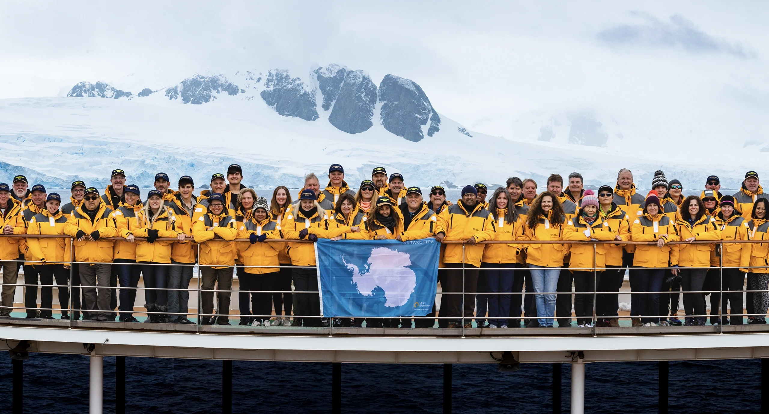 A conference group on the deck of an expedition ship in Antarctica